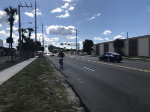 Before image of man riding his bike in an oncoming traffic lane on 25th St. in West Palm Beach