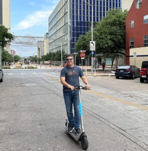Image of TPA Board and Executive Committee member Michael Napoleone on a scooter in an urban area